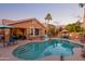 Relaxing kidney-shaped pool with surrounding patio and landscape at 6931 W Blackhawk Dr, Glendale, AZ 85308