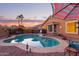 Inviting kidney-shaped pool with a patio and lighting at 6931 W Blackhawk Dr, Glendale, AZ 85308