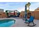 Inviting backyard oasis with a sparkling pool and patio furniture at 6931 W Blackhawk Dr, Glendale, AZ 85308