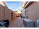 Landscaped side yard with a pathway and storage at 6931 W Blackhawk Dr, Glendale, AZ 85308