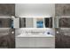 Double vanity bathroom with modern floating sink and large mirrors at 7180 E Kierland Blvd # 1116, Scottsdale, AZ 85254