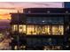 Modern condo building with illuminated windows and city views at dusk at 7180 E Kierland Blvd # 1116, Scottsdale, AZ 85254