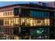 Night view of modern building exterior with large windows at 7180 E Kierland Blvd # 1116, Scottsdale, AZ 85254