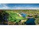 Aerial view of a golf course community with a lake and mountain views at 8136 E Beardsley Rd, Scottsdale, AZ 85255