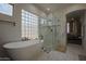 Spa-like bathroom with soaking tub, walk-in shower, and marble flooring at 8136 E Beardsley Rd, Scottsdale, AZ 85255