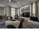 Bright living room featuring leather furniture, a large TV and access to backyard at 8136 E Beardsley Rd, Scottsdale, AZ 85255