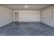 Attached single-car garage with concrete floor and light fixture at 829 E 9Th Pl, Mesa, AZ 85203