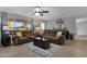 Spacious living room with brown sofas and large windows at 829 E 9Th Pl, Mesa, AZ 85203