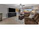 Living room with brown recliner sofas and a large TV at 829 E 9Th Pl, Mesa, AZ 85203