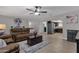 Open living room with kitchen view and brown sofas at 829 E 9Th Pl, Mesa, AZ 85203