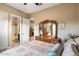 Spacious bedroom with ensuite bathroom and mirrored dresser at 8429 W Sands Ct, Peoria, AZ 85383