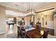 Open concept dining room with chandelier, adjacent to the Gathering room at 8429 W Sands Ct, Peoria, AZ 85383