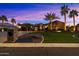 Beautiful home with palm trees and landscape lighting at dusk at 8429 W Sands Ct, Peoria, AZ 85383