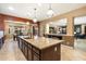 Large kitchen island with granite countertops and stainless steel appliances at 8429 W Sands Ct, Peoria, AZ 85383