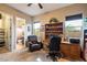 Home office with built-in desk, comfortable chair, and ample natural light at 8429 W Sands Ct, Peoria, AZ 85383