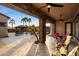 Covered patio overlooking a refreshing pool and lush landscaping at 8429 W Sands Ct, Peoria, AZ 85383