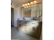 Stylish bathroom, featuring double vanity and large mirror at 9814 N Balboa Dr, Sun City, AZ 85351