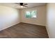 Bright bedroom with large window and ceiling fan at 9814 N Balboa Dr, Sun City, AZ 85351