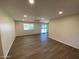 Spacious living room featuring wood-look floors and ample natural light at 9814 N Balboa Dr, Sun City, AZ 85351