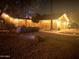 Well-lit desert home exterior at night with landscaping and walkway at 10043 E Dreyfus Ave, Scottsdale, AZ 85260