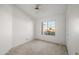 Bright bedroom with ceiling fan and large window at 10647 W Ross W Ave, Peoria, AZ 85382