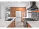 Modern kitchen with white countertops and wood cabinets at 1246 E Vista Ave, Phoenix, AZ 85020