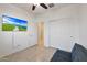 Bedroom with tiled floors, a sofa bed, and a view of the backyard at 12793 W Glenn Dr, Glendale, AZ 85307