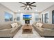 Bright and airy living room with a fireplace and built-in shelving at 14521 W Sheridan St, Goodyear, AZ 85395