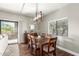 Dining area with wood table and chairs, and modern chandelier at 15225 N 100Th St # 2187, Scottsdale, AZ 85260