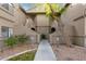 Condo building exterior showing walkway and landscaping at 15225 N 100Th St # 2187, Scottsdale, AZ 85260