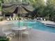 Community pool with patio furniture and umbrella at 15225 N 100Th St # 2187, Scottsdale, AZ 85260
