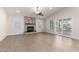 Living room with wood-look flooring, fireplace, and sliding door access to patio at 1562 W Flintlock Way, Chandler, AZ 85286