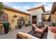 Outdoor patio with seating area and fountain feature at 15891 W Avalon Dr, Goodyear, AZ 85395