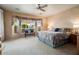 Serene main bedroom with a bay window, plush carpeting, and tasteful decor, creating a peaceful retreat at 15891 W Avalon Dr, Goodyear, AZ 85395