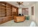 Home office with built-in wooden shelves and desk at 15891 W Avalon Dr, Goodyear, AZ 85395