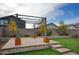 Backyard patio with pergola, artificial turf, and raised planter boxes at 19563 W Annika Dr, Litchfield Park, AZ 85340