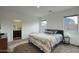 Bright bedroom with a king-size bed and en-suite bathroom at 19563 W Annika Dr, Litchfield Park, AZ 85340