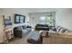 Spacious living room featuring a large sectional sofa and TV at 19563 W Annika Dr, Litchfield Park, AZ 85340