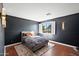 Dark-walled bedroom with a comfy bed at 2205 E Taurus Pl, Chandler, AZ 85249