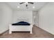 Bright bedroom with a white wooden bed frame and ceiling fan at 22414 W Meade Ln, Buckeye, AZ 85326