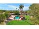 Inviting backyard with a sparkling pool, expansive lawn, and relaxing pergola at 2536 E Wood Pl, Chandler, AZ 85249