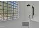 Clean and modern shower with black fixtures and a large glass block window at 2536 E Wood Pl, Chandler, AZ 85249