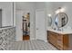 Contemporary bathroom with walk-in closet, patterned tile floor, and modern vanity at 2536 E Wood Pl, Chandler, AZ 85249