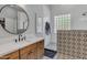 Modern bathroom with a walk-in shower, white subway tile, and a sleek vanity at 2536 E Wood Pl, Chandler, AZ 85249