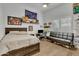 Bright bedroom with a bed, couch, and workspace at 2536 E Wood Pl, Chandler, AZ 85249