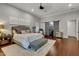 Spacious primary bedroom with wood floors,sliding barn door to closet, and en-suite bathroom at 2536 E Wood Pl, Chandler, AZ 85249