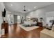 Bright and airy primary bedroom with hardwood floors and access to backyard patio at 2536 E Wood Pl, Chandler, AZ 85249