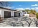 Three-car garage with dark brown doors and a gated driveway at 2536 E Wood Pl, Chandler, AZ 85249
