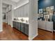 Butler's pantry with gray and white cabinets, quartz countertops, and wood floors at 2536 E Wood Pl, Chandler, AZ 85249