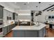 Modern kitchen with large island, stainless steel appliances, and white cabinets at 2536 E Wood Pl, Chandler, AZ 85249